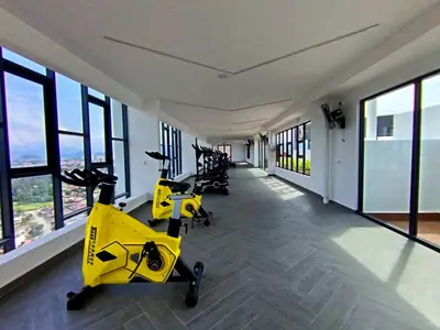 a gym with treadmills and exercise bikes in a building at The Horizon Ipoh 2BR L12 by Grab A Stay in Ipoh