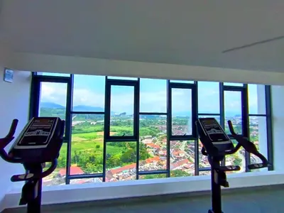 a room with two chairs and a large window at The Horizon Ipoh 2BR L12 by Grab A Stay in Ipoh