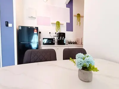 a kitchen with a table with a vase of flowers on it at The Horizon Ipoh 2BR L12 by Grab A Stay in Ipoh