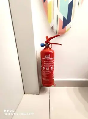 a red fire hydrant in front of a mirror at The Horizon Ipoh 2BR L12 by Grab A Stay in Ipoh