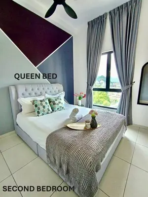 a bedroom with a queen bed with a table on it at The Horizon Ipoh 2BR L11 by Grab A Stay in Ipoh