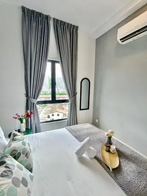 a bedroom with a large bed with a surfboard on it at The Horizon Ipoh 2BR L11 by Grab A Stay in Ipoh