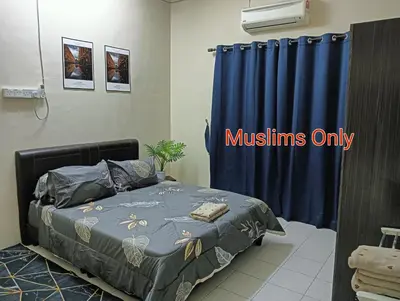 a bedroom with a bed and a blue curtain at Homestay Itqan Seri Iskandar in Seri Iskandar