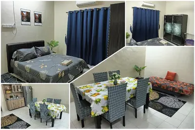 a room with a bed and a table and chairs at Homestay Itqan Seri Iskandar in Seri Iskandar