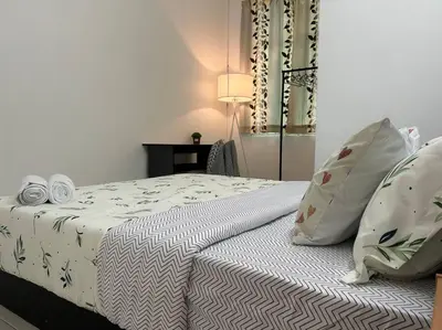 a bedroom with a bed with white sheets and pillows at Cendana House Juru Autocity Bkt Minyak Batu Kawan IKEA in Simpang Ampat
