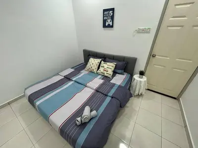 a bedroom with a bed with pillows on it at Cendana House Juru Autocity Bkt Minyak Batu Kawan IKEA in Simpang Ampat