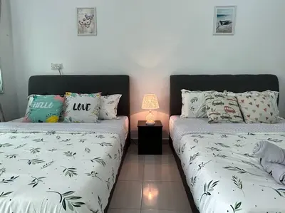 two beds sitting next to each other in a bedroom at Cendana House Juru Autocity Bkt Minyak Batu Kawan IKEA in Simpang Ampat