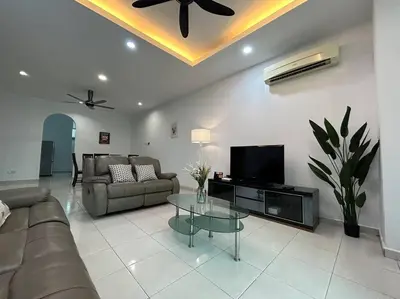 a living room with a couch and a tv at Cendana House Juru Autocity Bkt Minyak Batu Kawan IKEA in Simpang Ampat