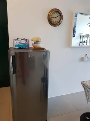a refrigerator in a room with a clock on the wall at BLUE DOME (Space) @ Night Market, Cameron. 2R2B in Brinchang