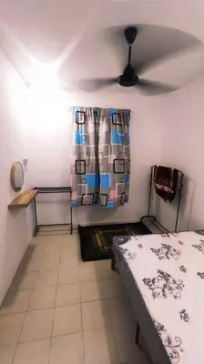 a bedroom with a bed and a ceiling fan at Alysha Homestay in Kuala Lipis