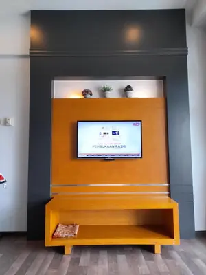a living room with a fireplace with a tv at Cameron Square in Brinchang