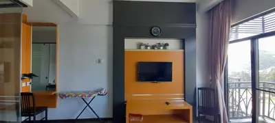 a living room with a tv on a wall at Cameron Square in Brinchang