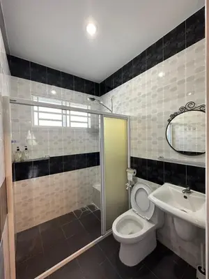 a bathroom with a toilet and a sink and a shower at Claire Home Stay in Ipoh
