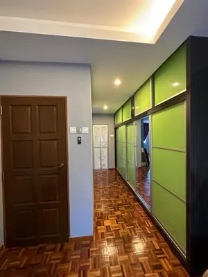 a hallway with green walls and a door at Claire Home Stay in Ipoh