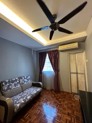 a living room with a couch and a ceiling fan at Claire Home Stay in Ipoh
