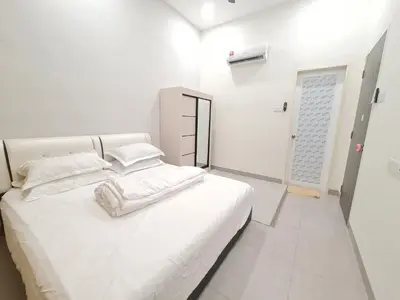 a white bedroom with a large white bed and a door at One Sweet Homestay Kulim Hi-Tech utk Msliim shj in Kulim