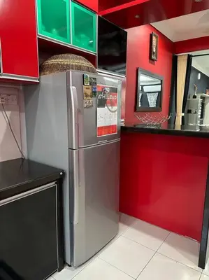 a kitchen with red cabinets and a stainless steel refrigerator at Pa&Ma HomeStay Kulim 4R3B fully aircond in Kulim