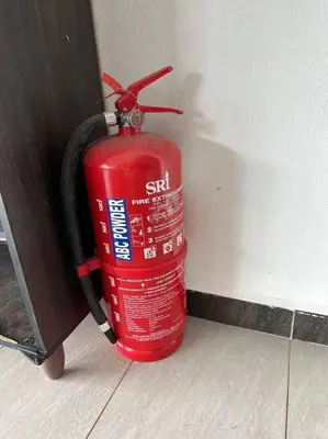 a red fire hydrant is attached to a wall at Pa&Ma HomeStay Kulim 4R3B fully aircond in Kulim