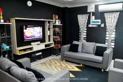 a living room with a couch and a tv at Pa&Ma HomeStay Kulim 4R3B fully aircond in Kulim