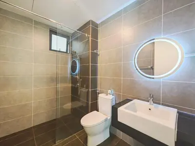 a bathroom with a toilet and a sink and a mirror at Sunway Onsen Suites - Theme Park Tambun Ipoh by Ryokan Management in Tambun