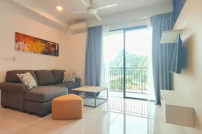 a living room with a couch and a large window at Sunway Onsen Suites - Theme Park Tambun Ipoh by Ryokan Management in Tambun