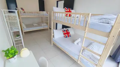 a room with two bunk beds and a table at Infinity Pool, Georgetown, Up to 11 Pax, 2 Bedrooms, 2 Bathrooms, 2 Car Parks by Star Home in Jelutong