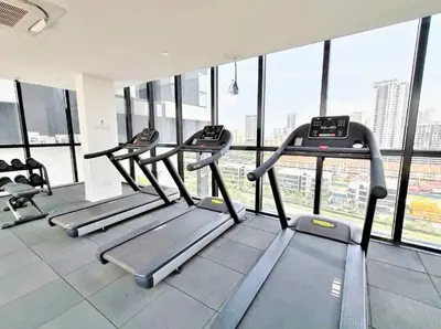 a gym with several tread machines in a building at Infinity Pool, Georgetown, Up to 11 Pax, 2 Bedrooms, 2 Bathrooms, 2 Car Parks by Star Home in Jelutong
