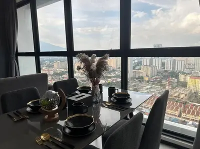a table with chairs and a vase of flowers on it at New Brand KTV SET, Netflix, 3 Queen Bed High Floor in Jelutong