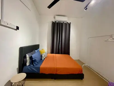 a bedroom with a bed with an orange blanket at Cozy64#6pax#Netflix#NearAeonAlma#BM#5kmtoIconicPoint in Bukit Mertajam