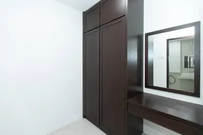 a bathroom with a mirror and a brown cabinet at Beach side spacious 5BR 20pax pool house in Batu Ferringhi