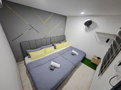 an overhead view of a bed in a small room at TL LEGEND HOMESTAY Ipoh garden east in Ipoh