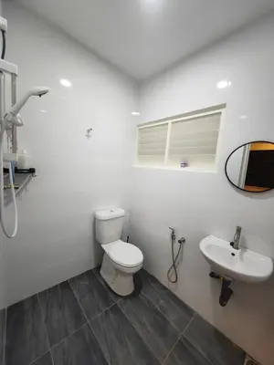 a white bathroom with a toilet and a sink at TL LEGEND HOMESTAY Ipoh garden east in Ipoh