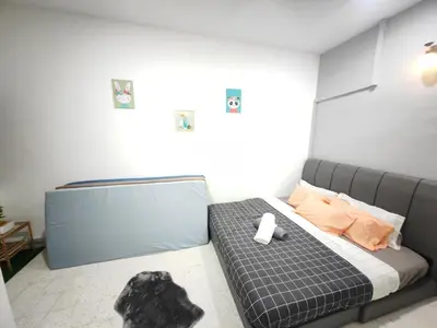a bedroom with a bed with a blue bed frame at TL LEGEND HOMESTAY Ipoh garden east in Ipoh