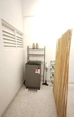 a small refrigerator in a room with a wall at TL LEGEND HOMESTAY Ipoh garden east in Ipoh
