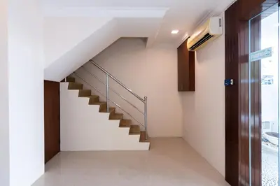a staircase in a house with white walls at Momostay in George Town