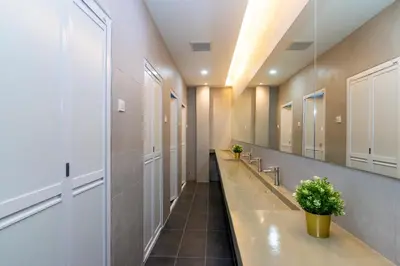 a hallway with a row of sinks and mirrors at Momostay in George Town