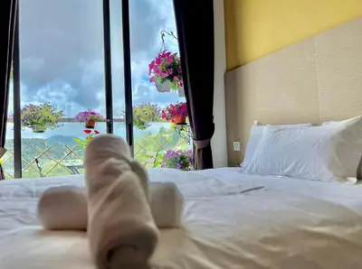 a teddy bear laying on a bed in front of a window at Kensington Sunrise sg, Palas Horizon,kea farm in Brinchang