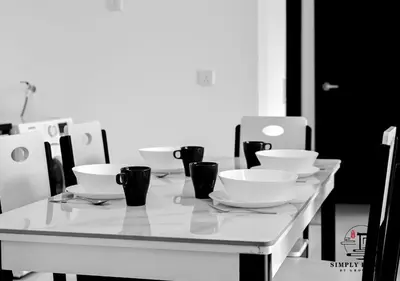 a table with bowls and cups on top of it at Urban Suites by Simply Penang in Jelutong