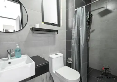 a bathroom with a toilet and a sink and a mirror at Urban Suites by Simply Penang in Jelutong