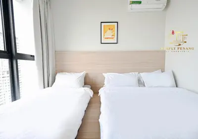 two beds in a room with white sheets at Urban Suites by Simply Penang in Jelutong