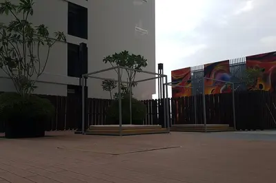 a black fence with two trees in front of a building at UN1 28 Jazz Massage Chair 5 min GMC Gurney \u5957\u623f in Tanjong Tokong