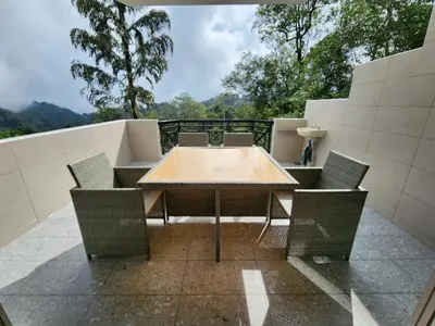 a table and chairs on top of a balcony at Little England B8-3 in Bukit Fraser