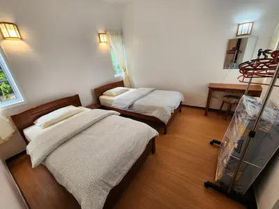 a room with two beds and a stretcher in it at Little England B8-3 in Bukit Fraser