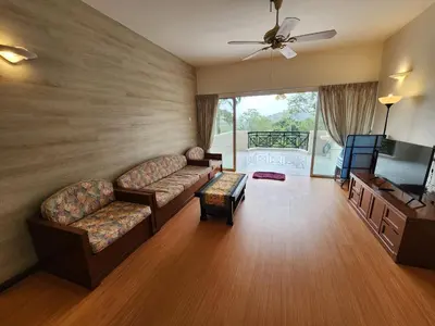 a living room with two couches and a television at Little England B8-3 in Bukit Fraser
