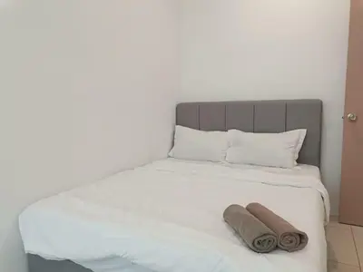 a bed with two towels sitting on top of it at Cozy 4 bedrooms House by Mr Homestay, 3 mins to Kulim Landmark Centre in Kulim