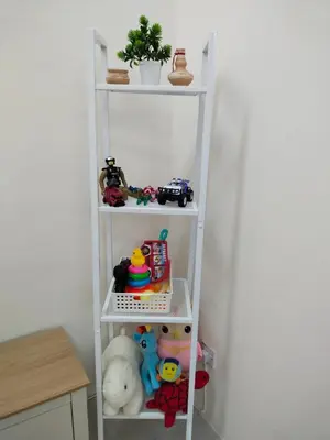 a white shelf with toys on it in a room at WAFID HOMESTAY 2 SERI ISKANDAR in Seri Iskandar