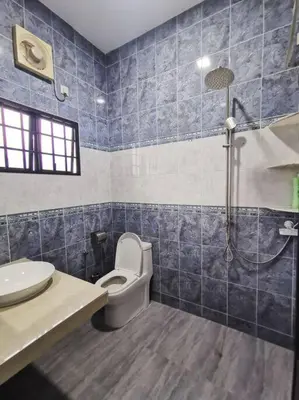 a blue tiled bathroom with a toilet and a shower at Ipoh stadium-18 pax (mahjong/5min to town) pets friendly in Ipoh