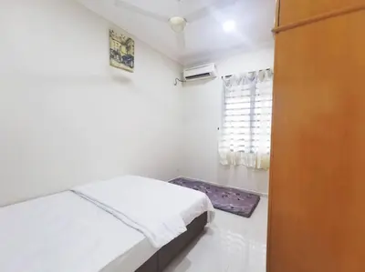 a small bedroom with a bed and a window at Ipoh stadium-18 pax (mahjong/5min to town) pets friendly in Ipoh