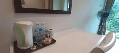 a bathroom counter with a fan and bottles of water at Rovers Inn Guesthouse - Age 11 And Above Only in Tanah Rata