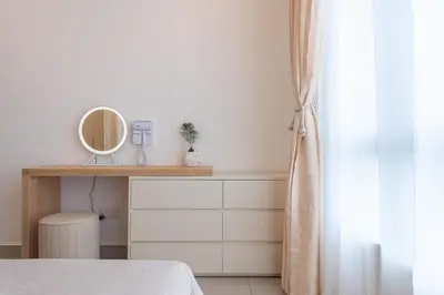 a bedroom with a dressing table and a mirror at Serene Muji Family Cottage(2-7pax) & Sunrise View in Cameron Highlands